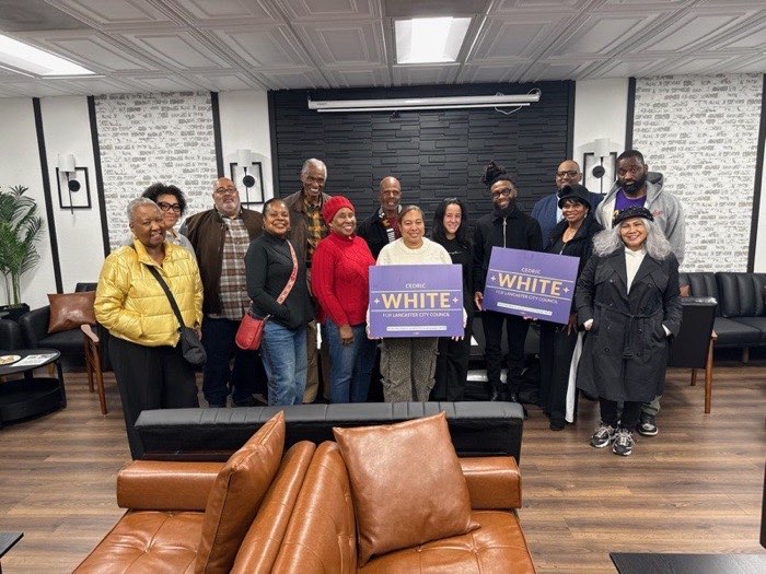 Cedric with campaign supporters holding signs